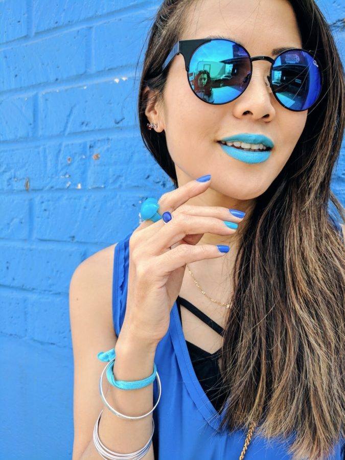 girl wearing blue sunglasses and blue lipstick on google pixel commercial