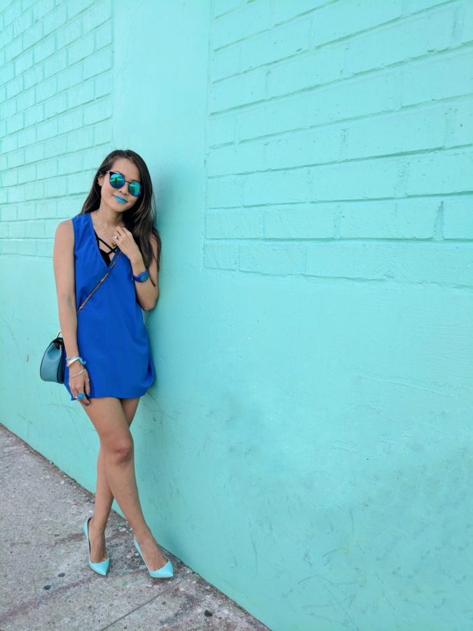 girl standing in front of tiffany blue wall