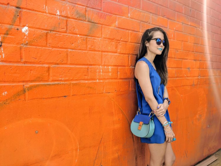 girl standing in front of orange wall